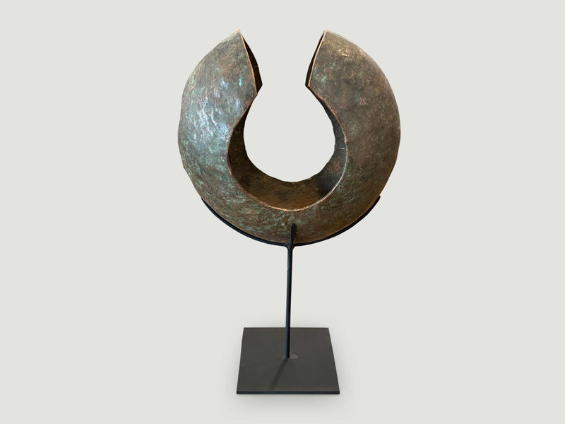 Copper African Currency on Modern Stand