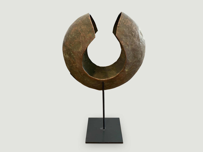 Copper African Currency on Modern Stand
