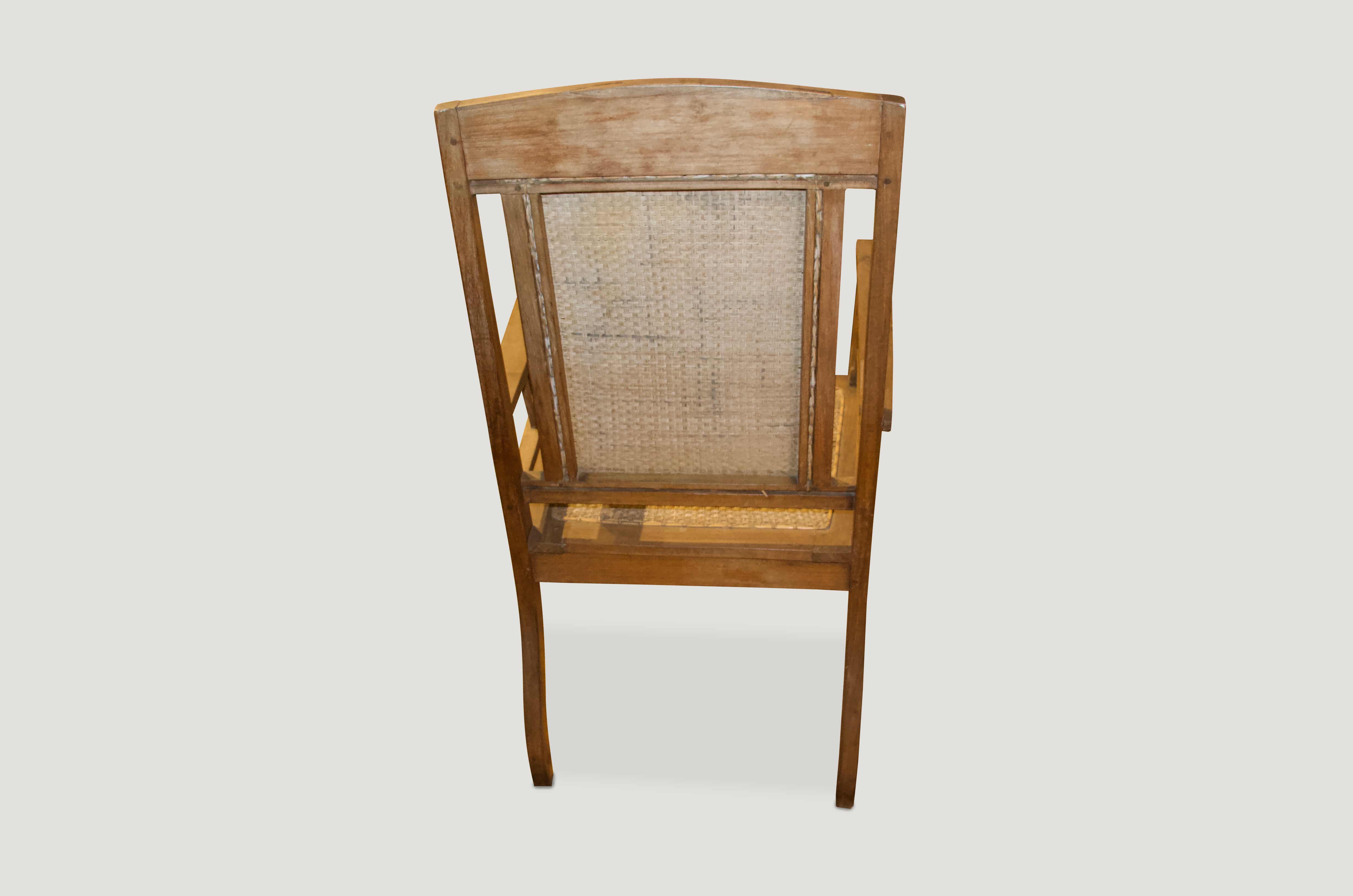 Antique Colonial teak chair with hand-woven rattan