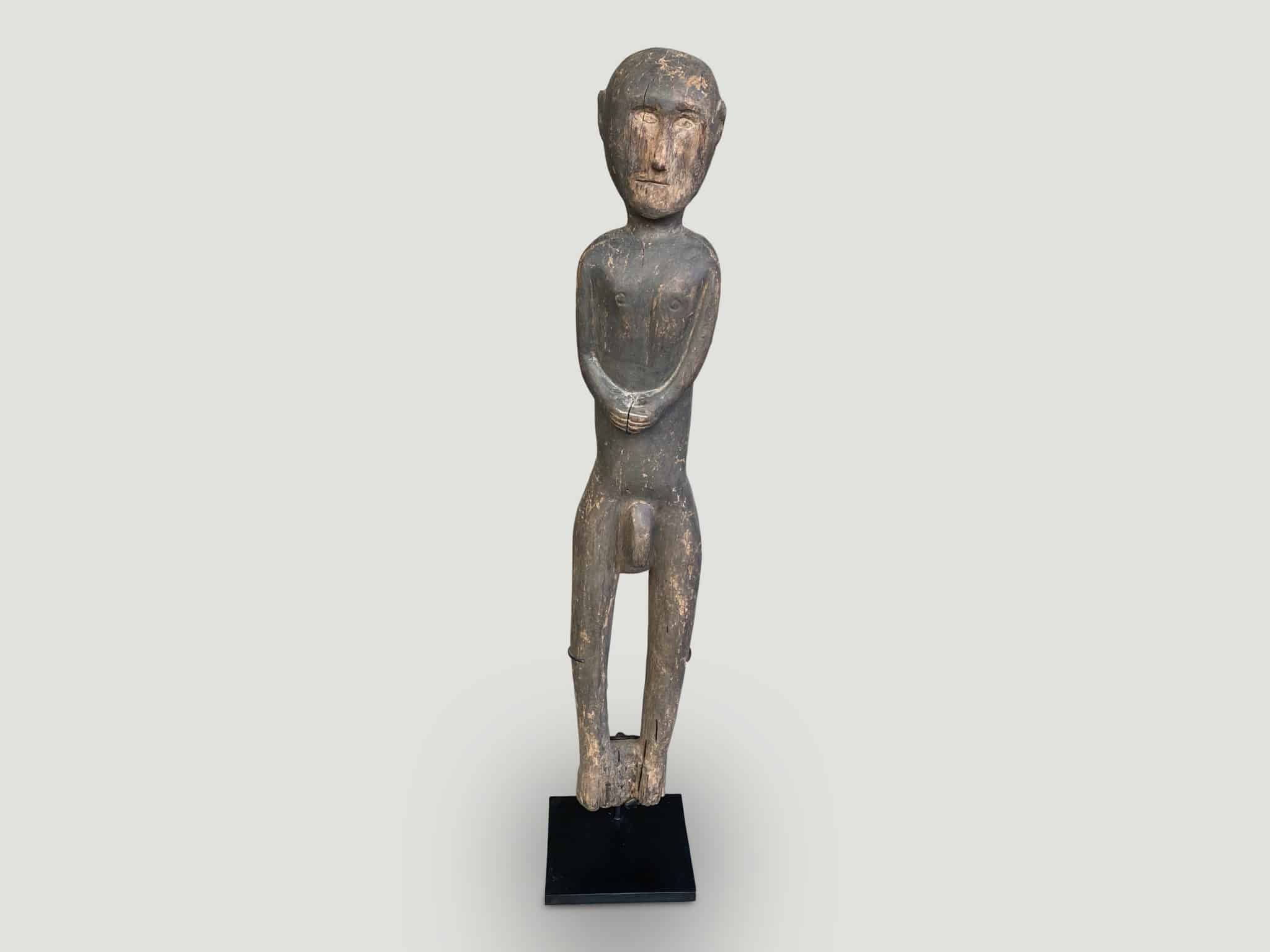 Antique male statue hand carved from a single wood log from Kodi Sumba