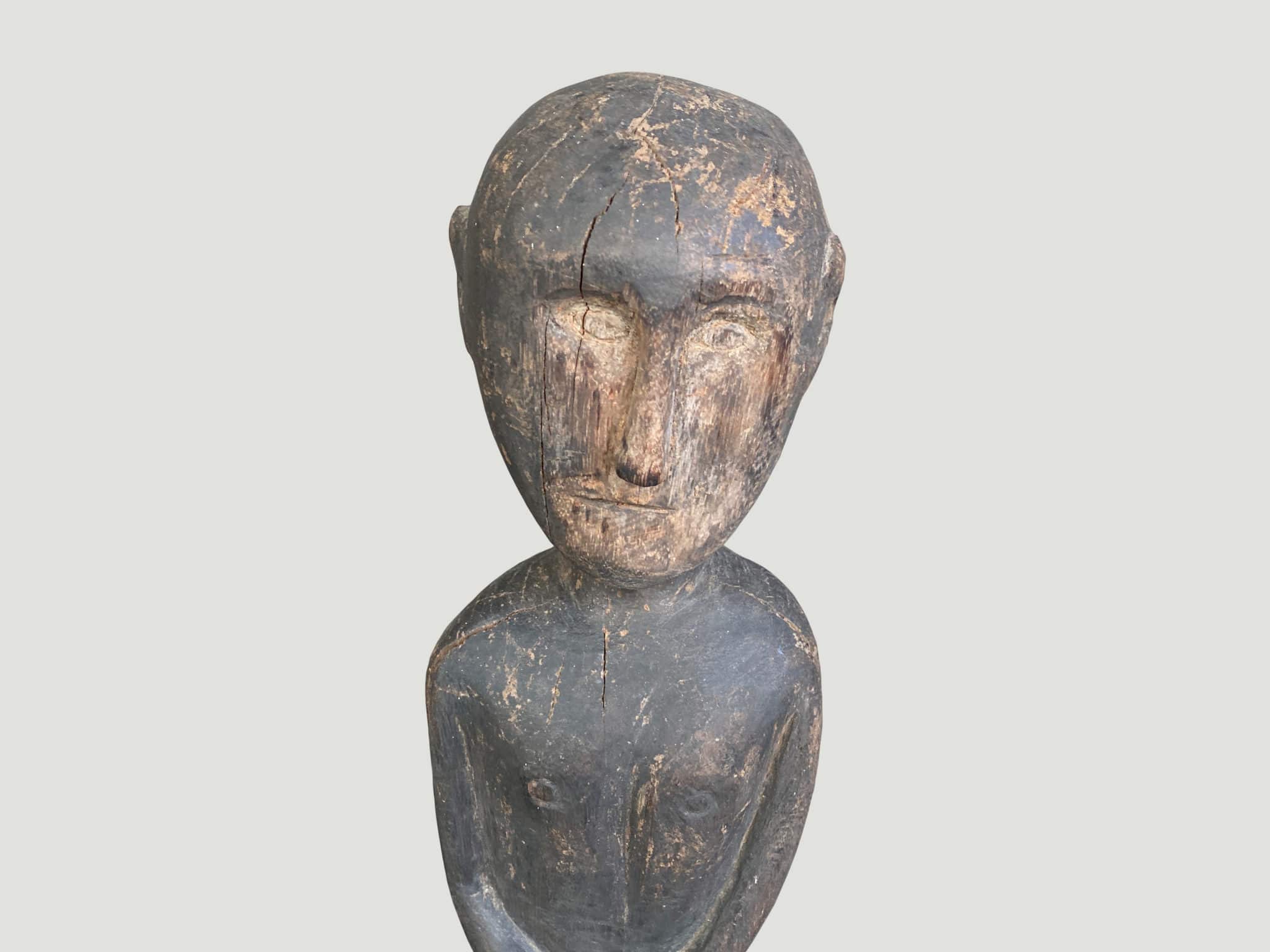 Antique male statue hand carved from a single wood log from Kodi Sumba