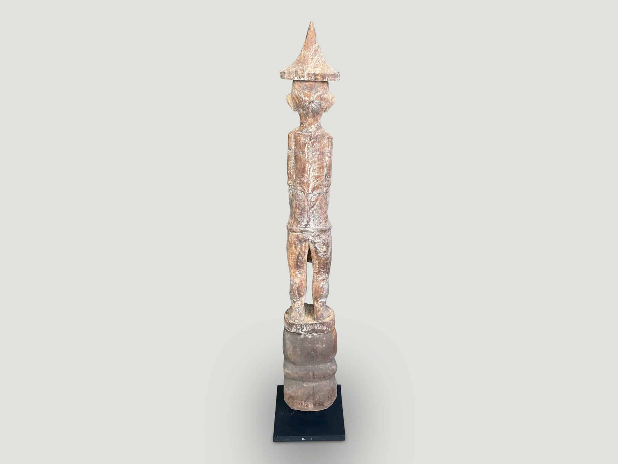 Antique male statue hand carved from a single wood log from West Borneo