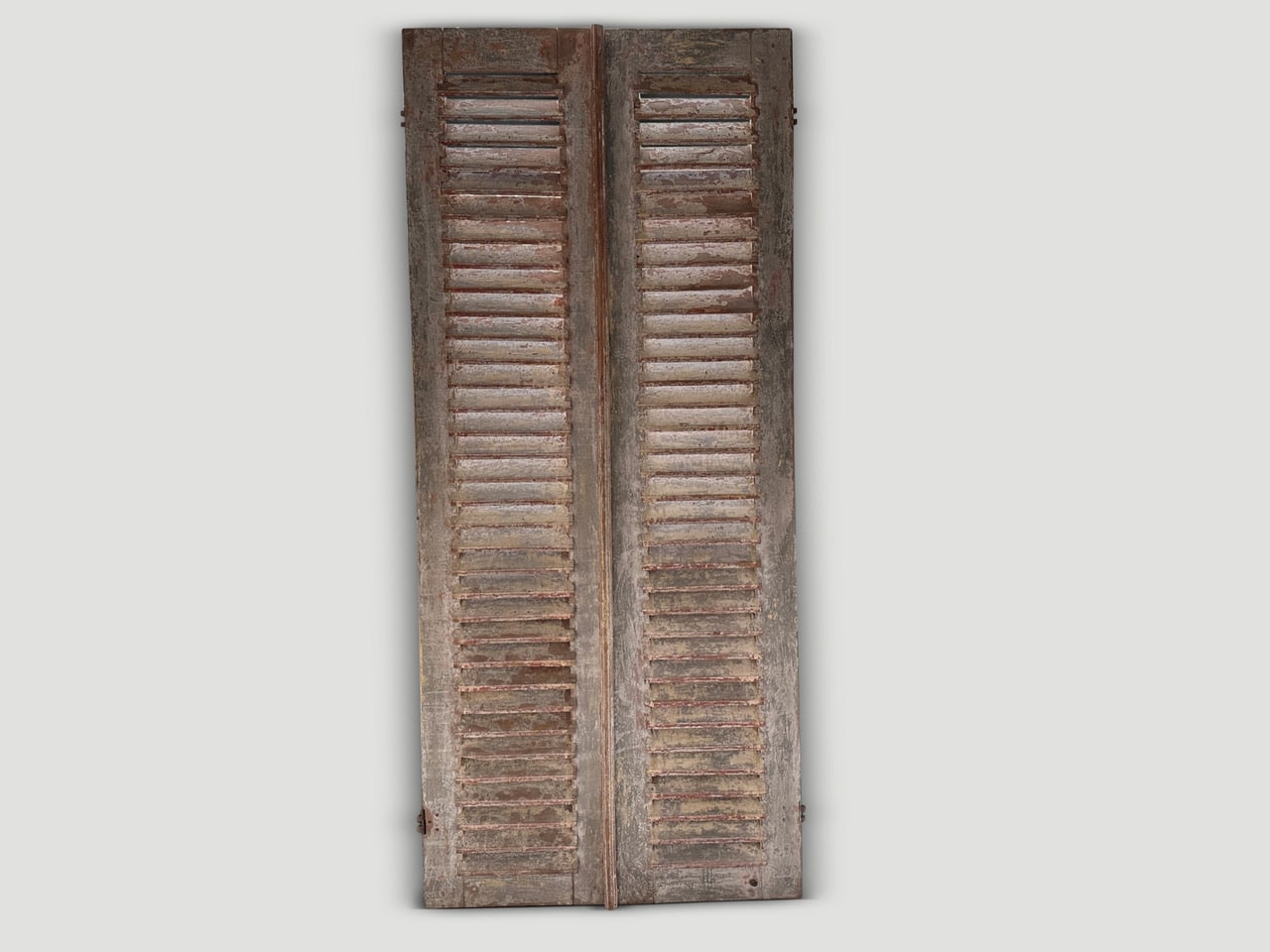 antique shutters with the remnants of the original color