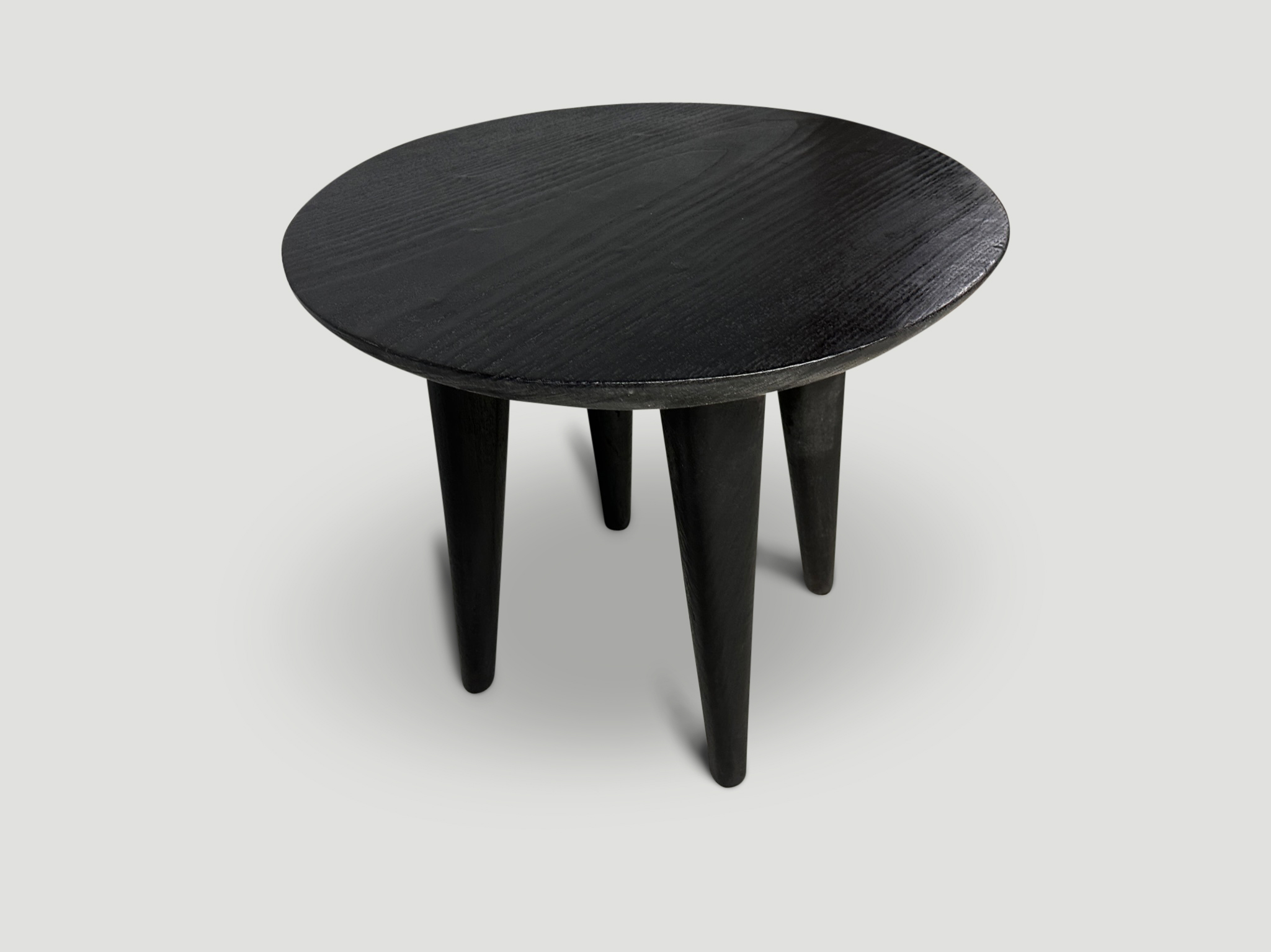 charred round side table