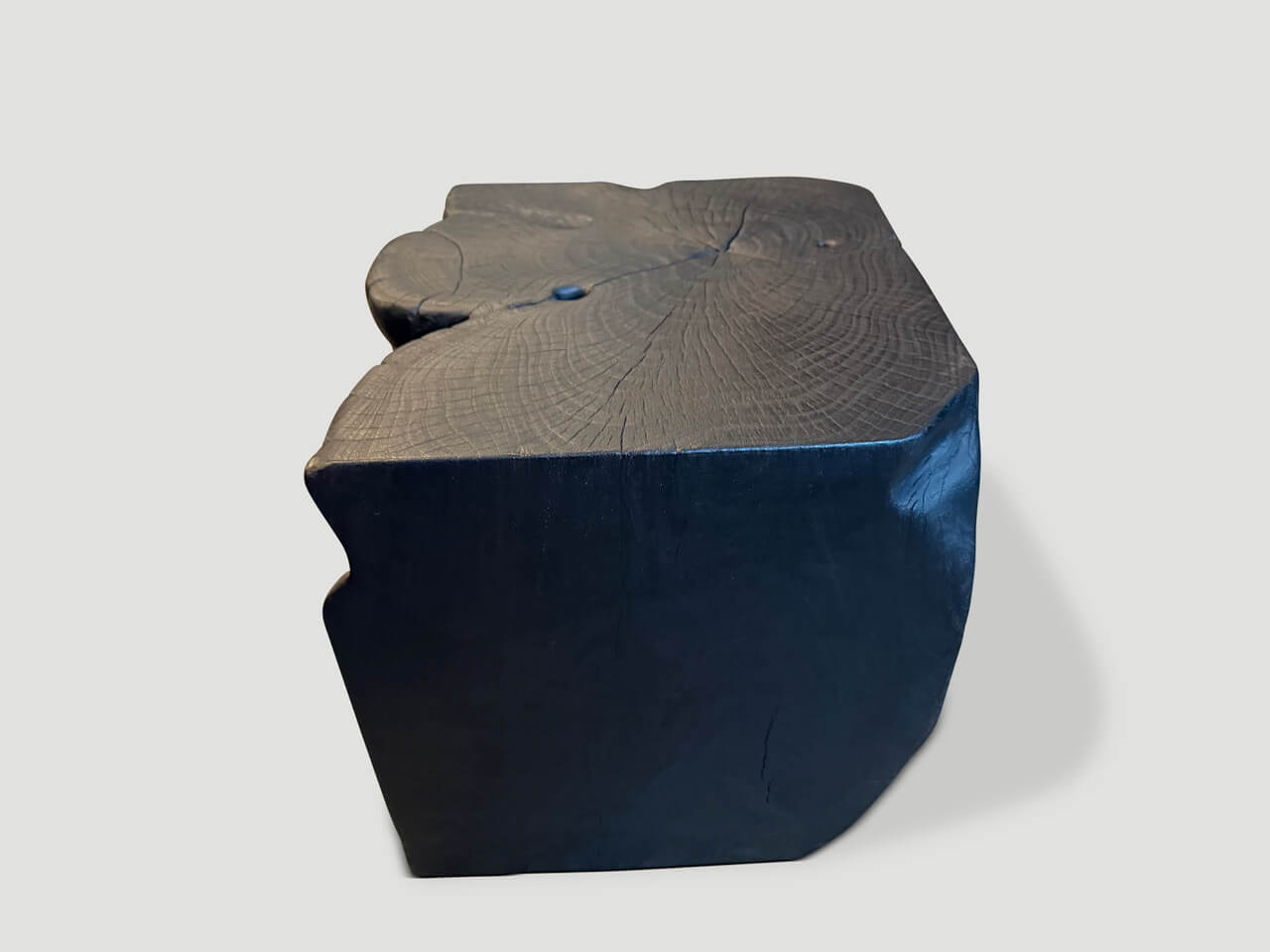 sculptural charred teak wood side table