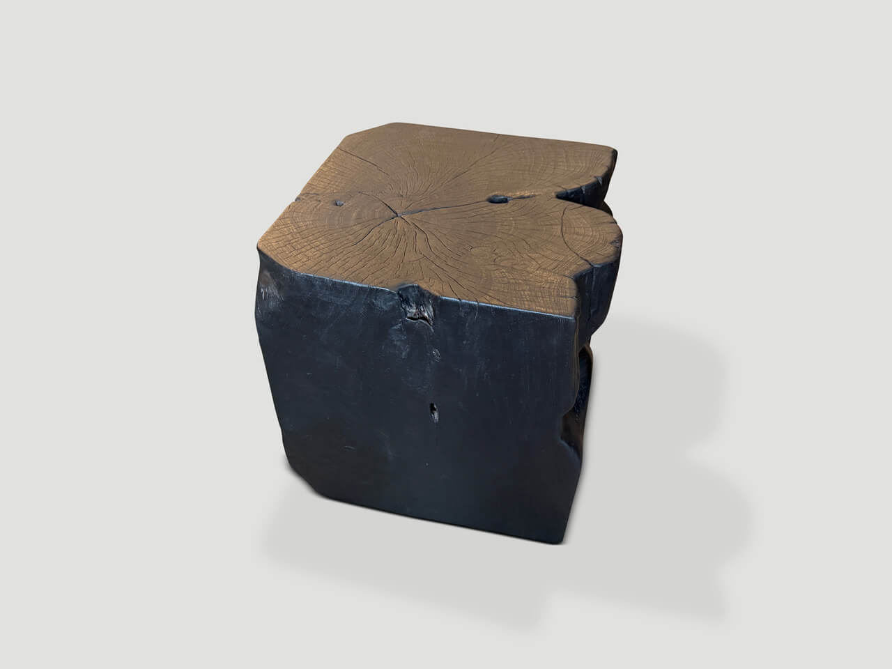 sculptural charred teak wood side table