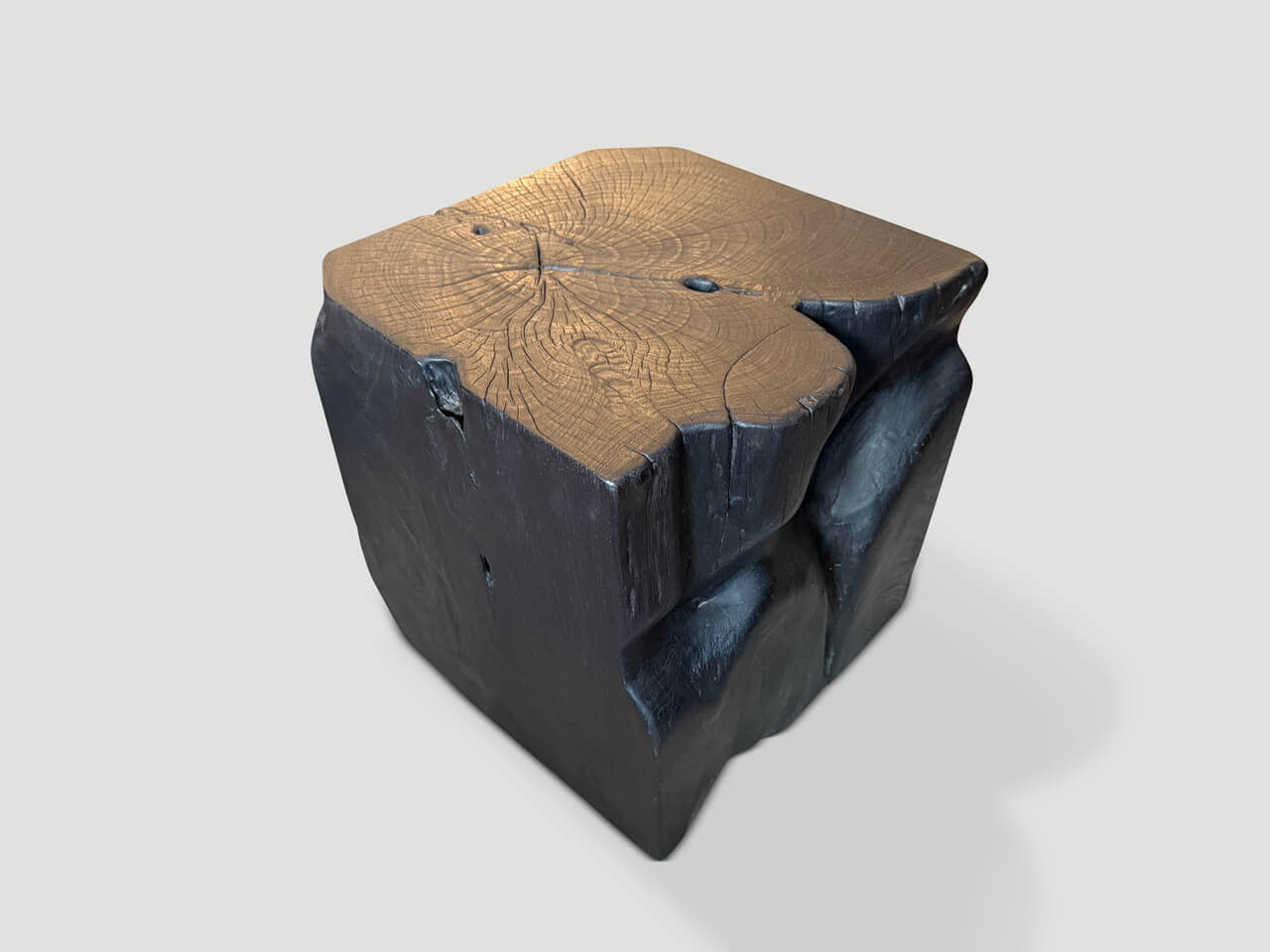 sculptural charred teak wood side table